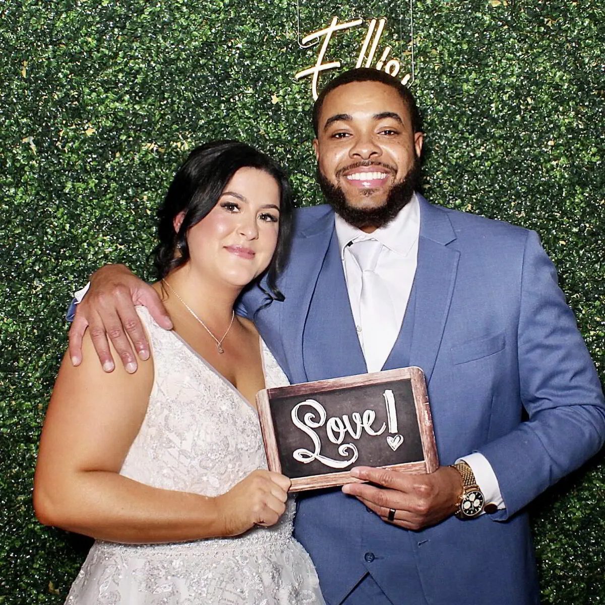 Wedding photo booth with hedge wall backdrop